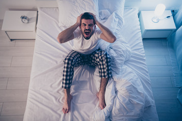 Top above high angle view of his he nice attractive depressed anxious devastated guy sitting on bed...