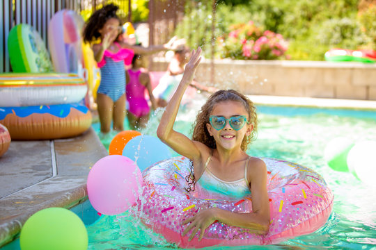 Summer pool fun cute girl splashing water