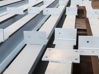 Stacked metal parts of a pre-fabricated building. Fast-built camp construction parts at the warehouse