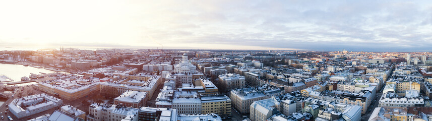 Beautiful winter panorama of the Old Town in Helsinki. Cathedral at sunset in Helsinki, Finland. Snow on the roofs.