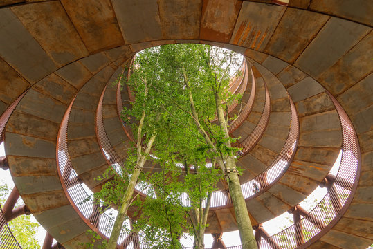A spiral shaped steel tower with beech trees gowing up in the middle. Outdoor activity for anyone not afraid of heights. Also for people with disabilities. Tourist attraction named Skovtårnet. Denmark