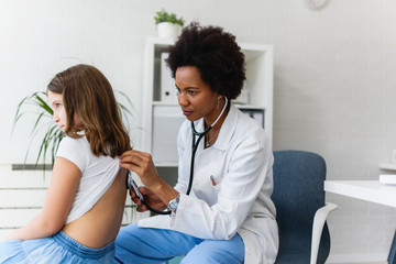 Doctor examining child with stethoscope. Respiratory disease diagnostics and treatment