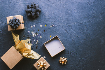 Christmas gifts on a black background. Open gift with stars.