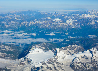 Obraz premium Aerial view above snow mountain peaks