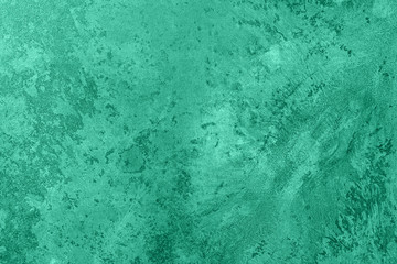 Fototapeta na wymiar Trendy mint colored low contrast Concrete textured background with roughness and irregularities to your design or product. Color trend concept.