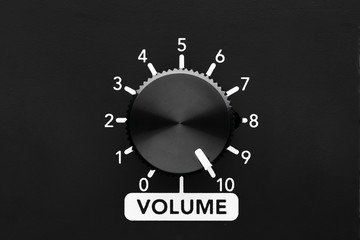 Volume control knob of a black amplifier on maxiumum loudness