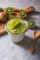 Healthy vegan chia pudding in a glass with fresh kiwi. Organic food concept