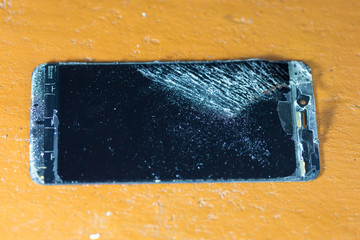 Dismantling a smartphone on a yellow table