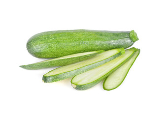 whole and sliced fresh zucchini on white background