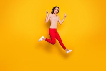 Fototapeta na wymiar Full size photo of lovely nice girl jump have spring free time make v-sign wear casual style clothes isolated over yellow color background