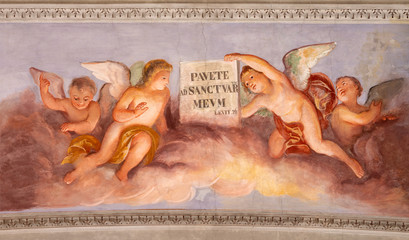 COMO, ITALY - MAY 8, 2015: The fresco of angels with the inscription from Old Tstament from the ceiling of church Basilica di San Fedele.