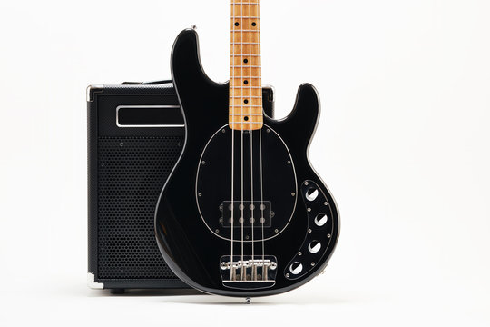 Vintage Black Electric Bass Guitar And Amplifier On White Background