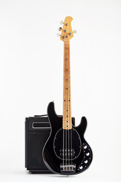 Vintage Black Electric Bass Guitar And Amplifier On White Background