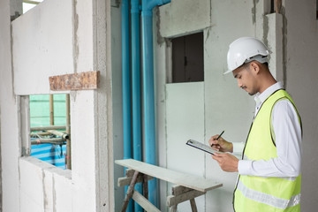 Engineer checking defect in construction site about line of soil and waste pvc pipe