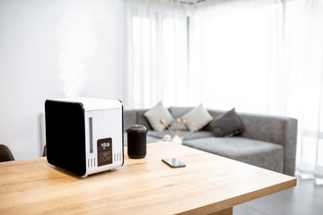 Working air humidifier on the table in the living room. Home air humidification concept