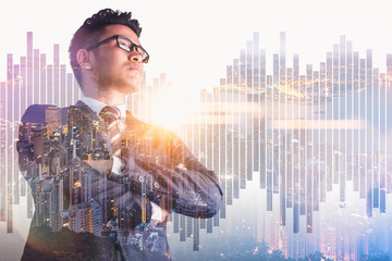 The double exposure image of the businessman standing back during sunrise overlay with cityscape image. The concept of modern life, business, city life and internet of things.