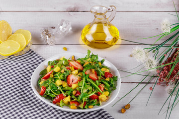 Strawberry salad with arugula, mango and pistachios with lemon and olive oil.