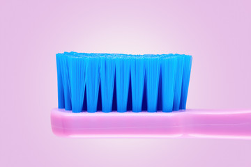 Close up side view of a new purple toothbrush on purple background