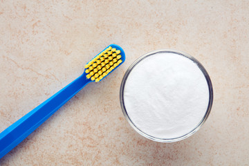 Toothbrush and baking soda in a bowl