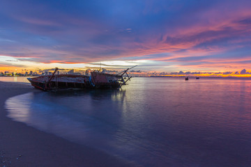 Old shipwrecked on the beach Shipwreck at Krating Beach, Pattaya, Thailand