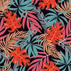 Fashionable seamless tropical pattern with bright pink and yellow plants and leaves on dark background. Jungle leaf seamless vector floral pattern background.  Tropical botanical.