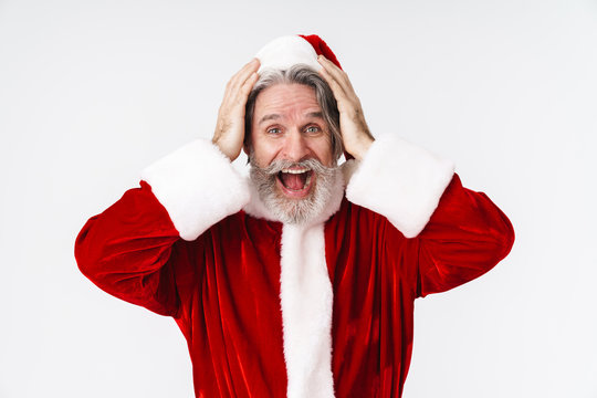 Image of happy old Santa Claus man in red costume grabbing his head