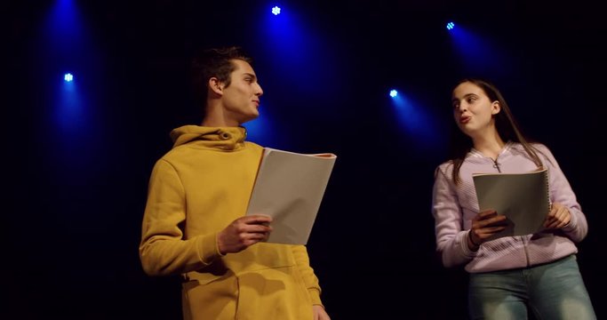 Teenagers rehearsing in a theatre