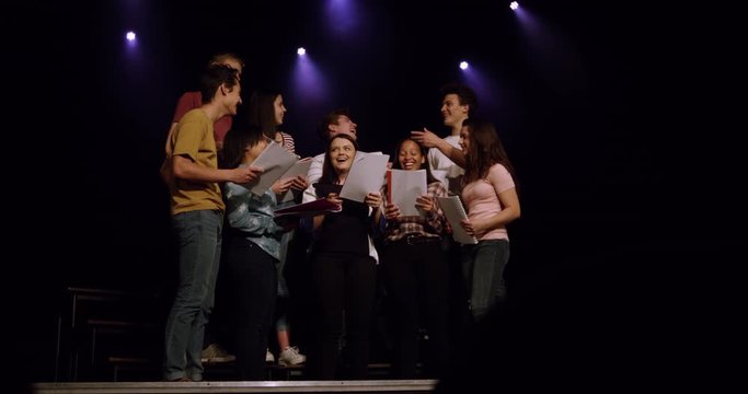 Teenagers rehearsing in a theatre