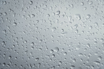 rain drop on glass texture. rainy season background  