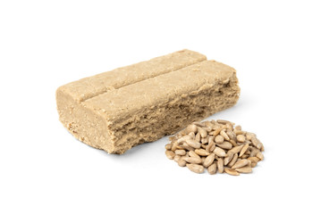 Halva and sunflower seeds isolated on white background.