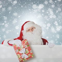 Santa Claus pointing in blank advertisement winter banner with copy space