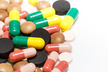 Various pills and capsules on white background closeup view