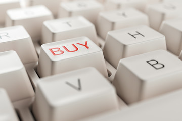 Macro view on retro pc keyboard with  buy key. Financial trading and online shopping concept.