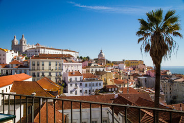 Fototapeta na wymiar Lisbon, Portugal: Aerial View of the Old Alfama Quarter on the Hill with Blue Sky
