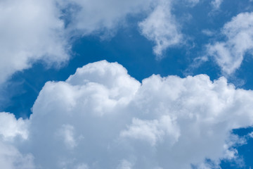 Obraz premium Soft blue sky with clouds and sun flare.