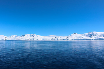 Snow-capped mountains on an island along the coasts of the Antarctic Peninsula, Palmer Archipelago, Antarctica