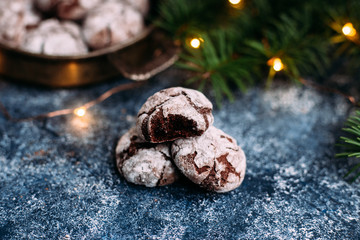 Chocolate Crinkle Cookies on a blue table. New Year, Christmas