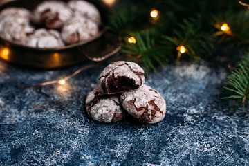 Chocolate Crinkle Cookies on a blue table. New Year, Christmas