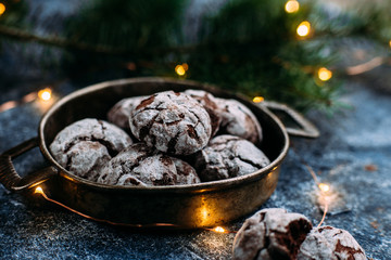 Chocolate Crinkle Cookies on a blue table. New Year, Christmas
