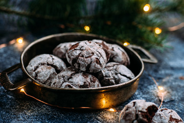 Chocolate Crinkle Cookies on a blue table. New Year, Christmas