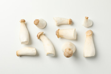 Flat lay with eringi mushrooms on white background, space for text
