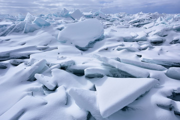 Fototapeta na wymiar Landscape of blue ice shards and snow covered shoreline of Lake Michigan, Sleeping Bear Dunes, Michigan, USA
