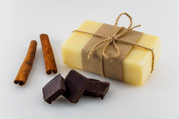 Yellow handmade soap with chocolate and cinnamon on white background