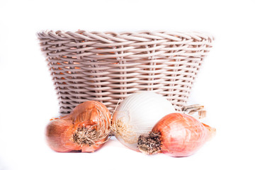 shallots in a wicker basket on a white background