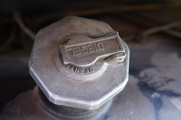 Truck fuel tank cover is full of dust and oil stains.