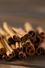 spicy cinnamon sticks on wooden surface