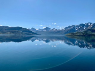 Fototapeta na wymiar Reflections of mountains in the fjord, ⁨Halsa⁩, ⁨Nordland⁩, ⁨Norway⁩