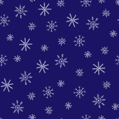 Fototapeta na wymiar Seamless pattern on a dark background. Pattern of white snowflakes on a blue sky. Winter pattern for design.