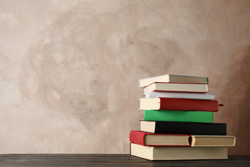 Stack of books against brown, space for text Stack of books against brown, space for text