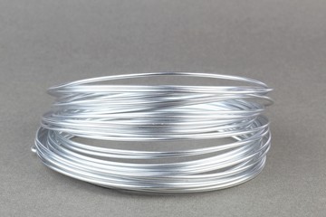 Coil of silver wire on a light background.